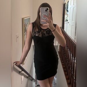 Gorgeous tight fitting black dress with rose patterned mesh on front and back